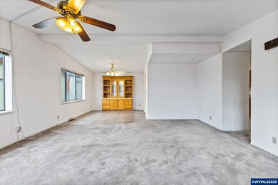 Living room looks into the dining room with built in china cabinet.