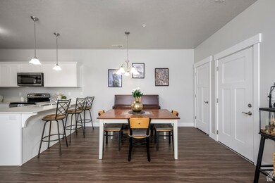 Dining room featuring dark wood finished floors and a chandelier