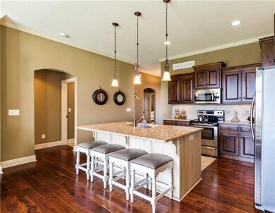 The warm cathedral cabinetry with large crown real