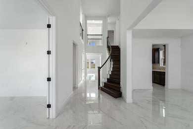 Grand two-story entryway features soaring ceilings