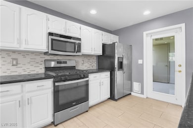 Kitchen with stainless steel appliances, white cab