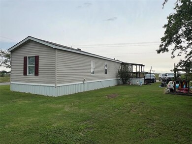 View of side of home with a lawn