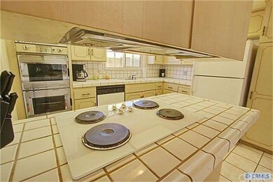 Kitchen with a view of the range and double ovens.