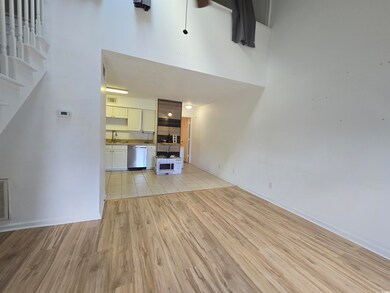 Unfurnished living room with sink and light tile p