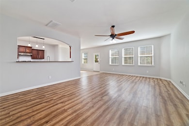 Spacious living room opens to the dining room & kitchen. Tons of natural lighting with the wall of windows overlooking the backyard.
