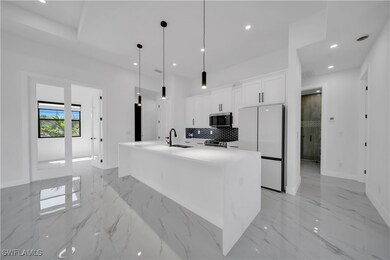 Kitchen featuring white cabinets, stainless steel