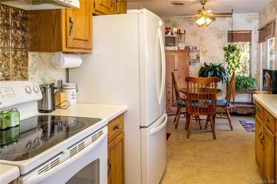 Galley eat-in kitchen with oak cabinets and nice appliances
