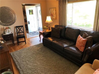 The newly refinished hardwood floors gleam with li