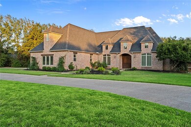 French provincial home featuring a front yard