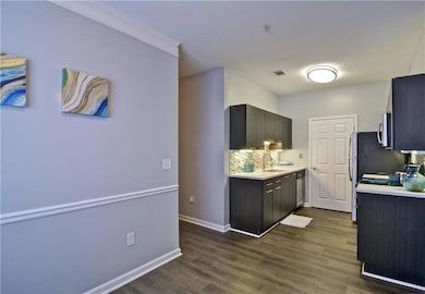 Kitchen with stainless steel appliances, sink, backsplash, dark hardwood / wood-style floors, and wine cooler