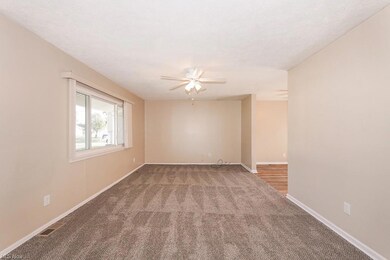 Empty room featuring ceiling fan and carpet