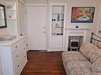 Living area featuring built in shelves, dark wood
