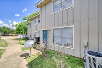 View of side of home with board and batten siding and a yard