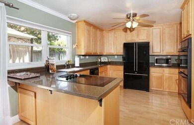 Upgraded kitchen cabinets, counter top, newer counter-depth refrigerator, double oven, laminate wood flooring and crown molding.