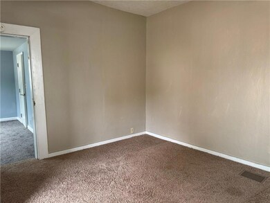 Living room featuring carpet floors and a textured ceiling