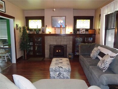 Cozy living room with original wood built ins, gas