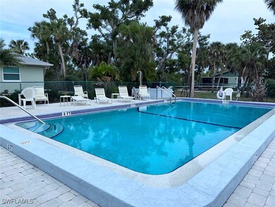 Pool with a patio area and fence