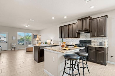 Kitchen with dark brown cabinets, a kitchen islan