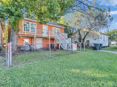 The front entry shows off the home’s bright exterior and raised structure, perfect for island weather. A few steps up lead you to your private front porch—an easy spot to relax and enjoy the breeze.
