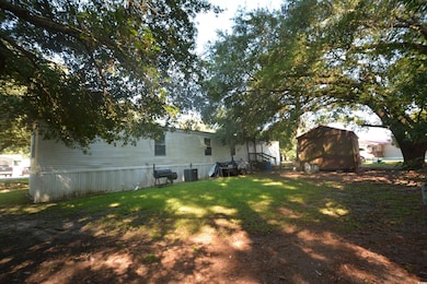 View of green lawn featuring a shed