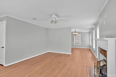 Unfurnished living room featuring ornamental moldi
