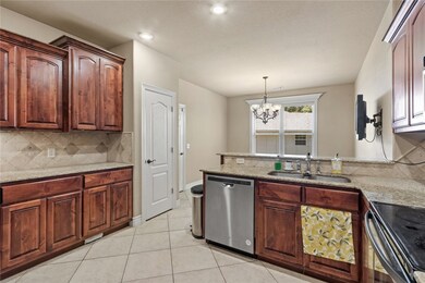Kitchen has eat-in area on other side of countertop,  Door to the right is pantry.