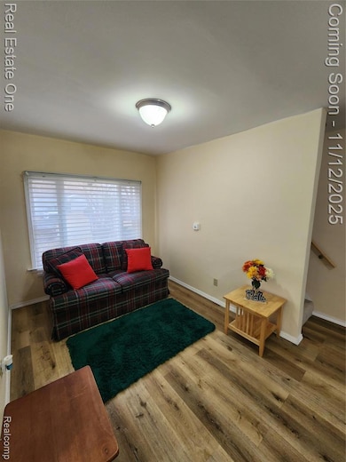 Living area featuring wood finished floors and baseboards
