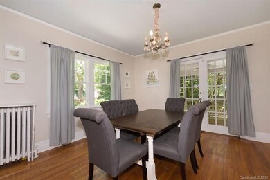 Formal dining room with French doors leading outsi