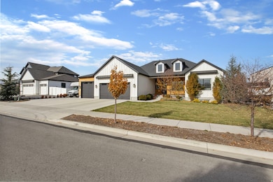 Modern inspired farmhouse with driveway, a front lawn, an attached garage, and board and batten siding