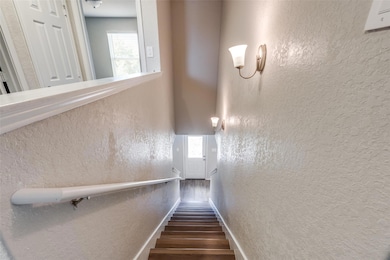 Staircase featuring baseboards, wood finished flo