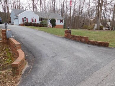 Brick entrance with paved driveway