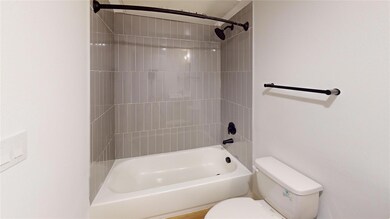 Bathroom featuring toilet and bathing tub / shower