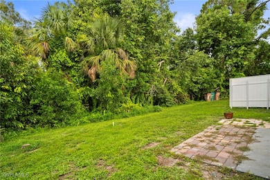View of grassy yard featuring a patio