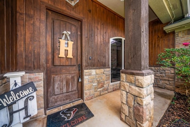 Property entrance featuring stone siding