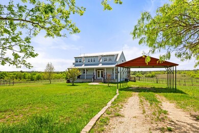 Rear view of property featuring fence, a gazebo, 