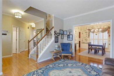 Open flow from Living room into dining room. Notice the beautiful wood floors