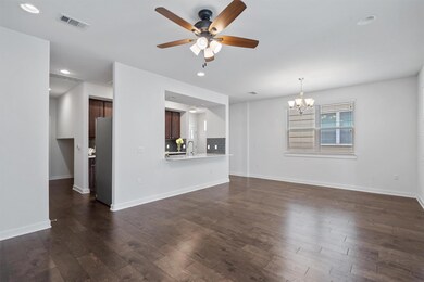 Unfurnished living room featuring a ceiling fan, 