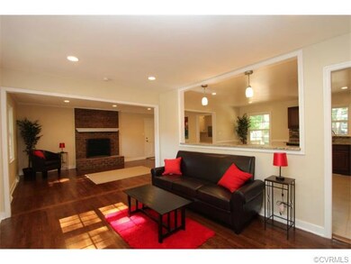 Open floor plan features refinished hardwoods thro