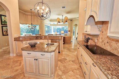 Kitchen with arched walkways, a chandelier, decora