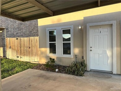 Property entrance featuring fence, a patio, and stucco siding