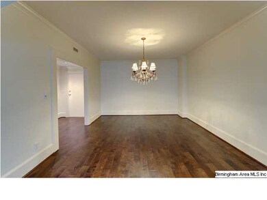 Beautiful hardwood floors and crown molding throug
