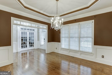 View from dining into foyer highlights seamless flow and front office access.