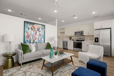 Living area with light wood finished floors and v