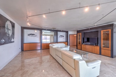Living area with track lighting and baseboards