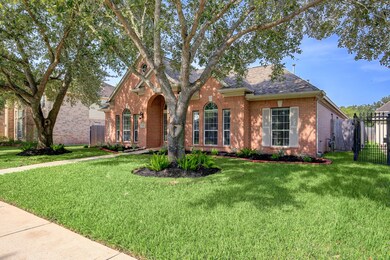 The front yard has two mature trees, providing shade and privacy.