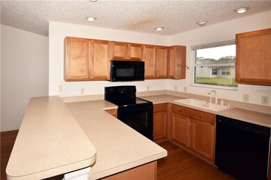 Kitchen with Kenmore appliances and breakfast bar.