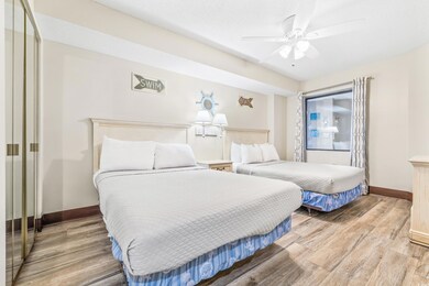 Bedroom featuring ceiling fan, a textured ceiling,
