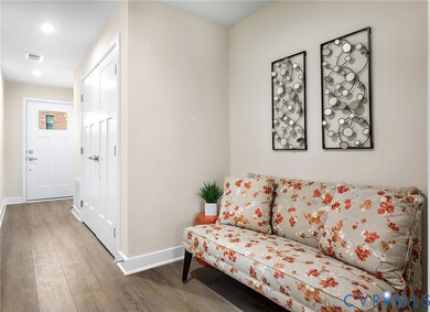 Living area with wood finished floors and recessed lighting