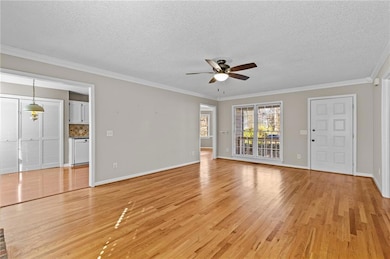 Unfurnished living room featuring light wood-style