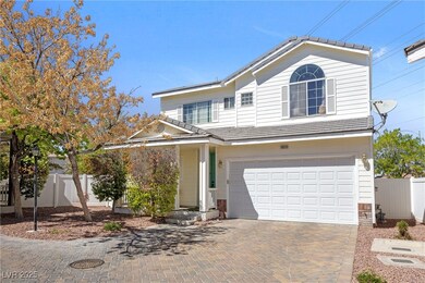 Traditional-style home with decorative driveway, a